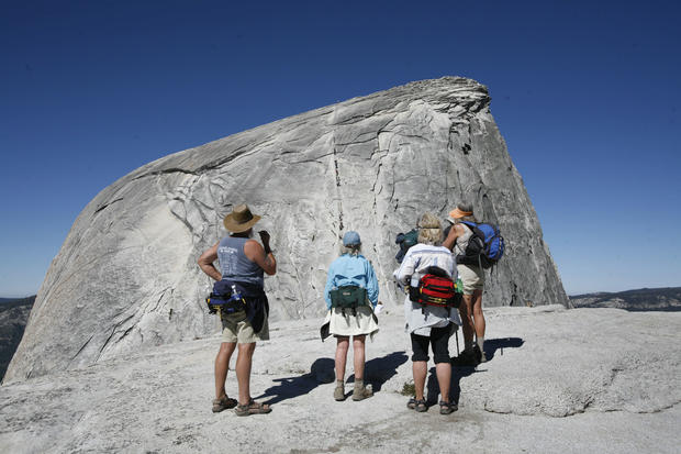 Early in the morning before the crowds arrived, a group of hikers look at the Half Dome cable section in Yosemite National Park on June 30, 2007. 
