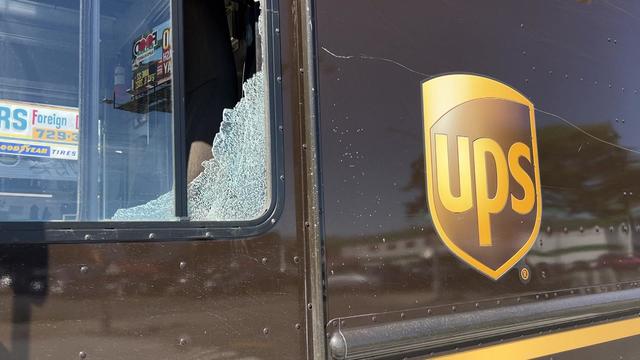 A UPS truck with a smashed driver's side window 