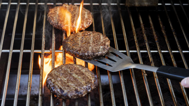 Burgers cooking onbarbecue grill 