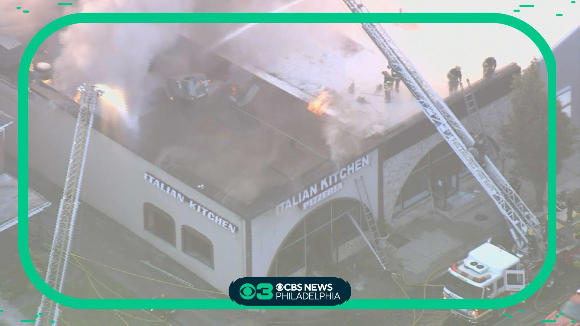 Firefighters on roof responding to Overbrook pizzeria fire - CBS