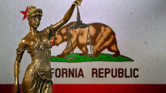 Lady Justice before a flag of California 