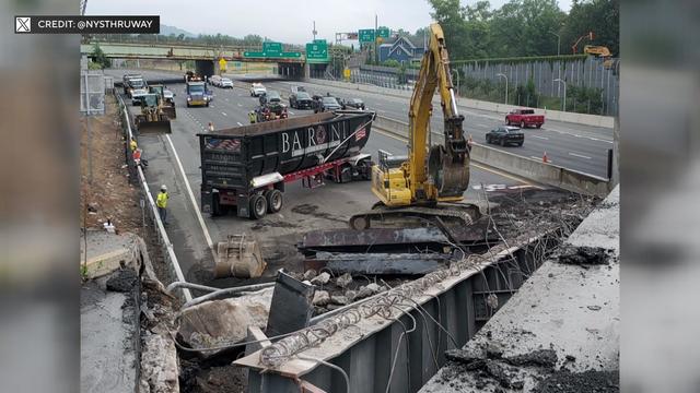 Construction vehicles work on an overpass on the New York State Thruway. 