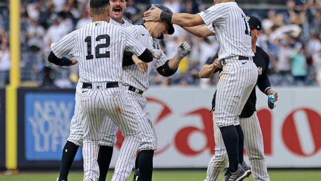 Kyle Higashioka (C) #66 of the New York Yankees is congratulated by his teammates after hitting a walk-off double to defeat the Milwaukee Brewers by 4-3 in the bottom of the thirteenth inning at Yankee Stadium on September 10, 2023 in the Bronx borough of 