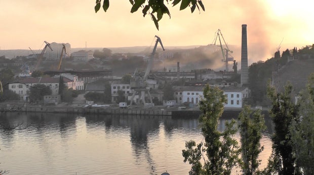 Smoke rises from the shipyard that was reportedly hit by Ukrainian missile attack in Sevastopol