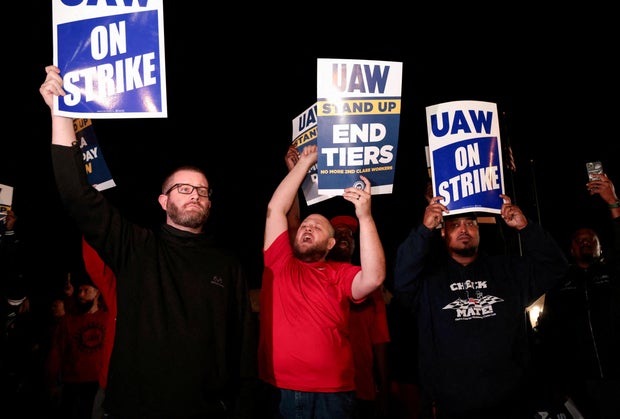 FILE PHOTO: United Auto Workers hold up strike signs right across from the Ford Michigan Assembly Plant in Wayne