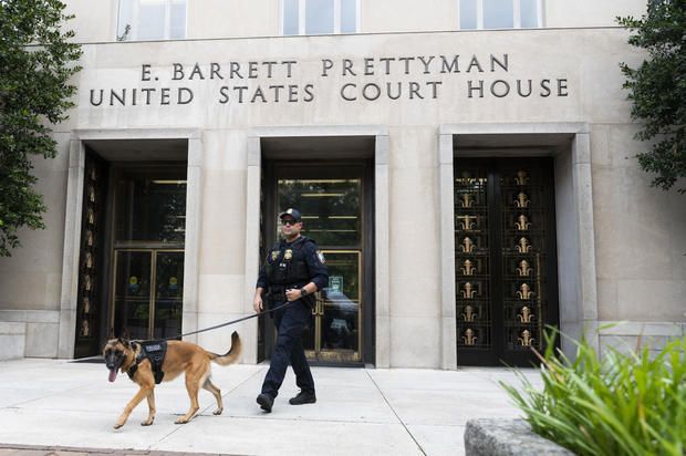A Homeland Security canine unit sweeps one of the entrances to the E. Barrett Prettyman United States Courthouse in Washington, D.C., on Aug. 3, 2023. 