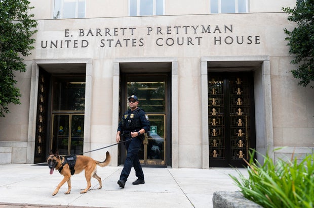 A Homeland Security canine unit sweeps one of the entrances to the E. Barrett Prettyman United States Courthouse in Washington, D.C., on Aug. 3, 2023.
