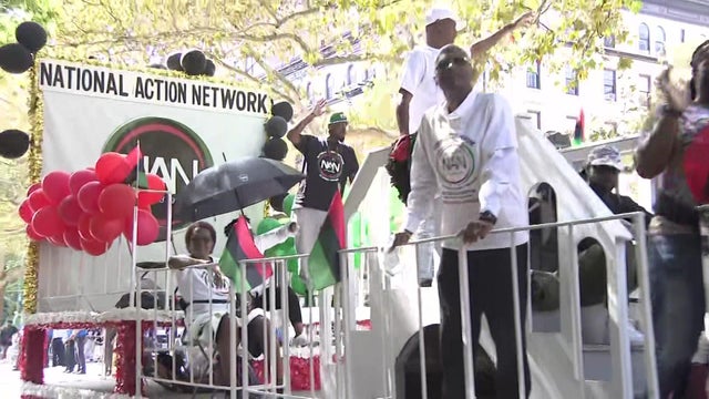 Individuals on a National Action Network float during the African American Day Parade in Harlem.