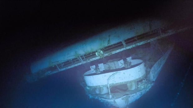 The strong starboard list of USS Yorktown on the seafloor can be seen in the flight deck, also collapsing towards the starboard side at the bow with an anti-aircraft gun tub below. Photo captured by ROV Atalanta on September 9-10, 2023