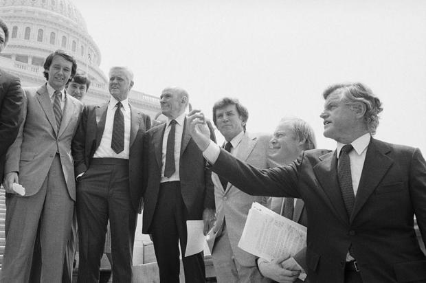 Members of Congress opposed to the MX missile hold a rally on the Capitol steps on June 14, 1983. From left to right: Rep. Edward Markey; Sen. Ernest Hollings; Sen. Alan Cranston; Sen. Gary Hart; Rep. Jim Leach; and Sen. Edward Kennedy. 