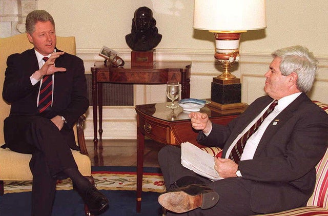 President Bill Clinton speaks to House Speaker Newt Gingrich during a budget meeting at the White House on Dec. 19, 1995. 