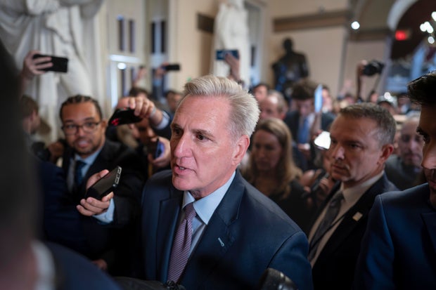 Speaker of the House Kevin McCarthy is surrounded by press and police on the way to the House chamber at the Capitol in Washington on Tuesday, Oct. 3, 2023.