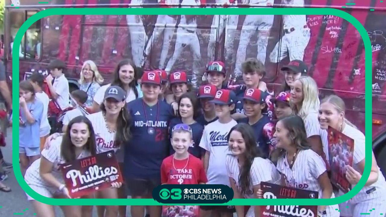 Phillies fans celebrate during Rally for Red October bus tour