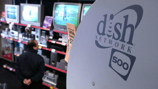 A dish network satellite is on display as a customer looks o 