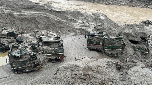 FILE PHOTO: Trucks buried in mud are seen in an area affected by flood in Sikkim 