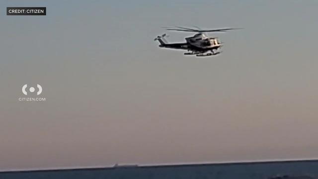 A helicopter over the water at Rockaway Beach. 