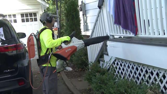 A landscape company employee uses a leaf blower in Montclair, New Jersey. 