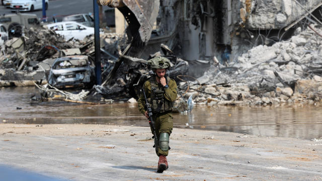 An Israeli soldier patrols near a police station following a mass infiltration by Hamas gunmen from the Gaza Strip, in Sderot 