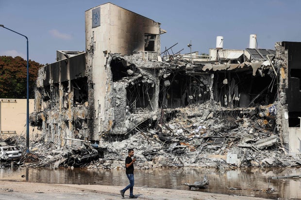 A man walks past an Israeli police station in Sderot after it was damaged during battles to dislodge Hamas militants who were stationed inside, on October 8, 2023.