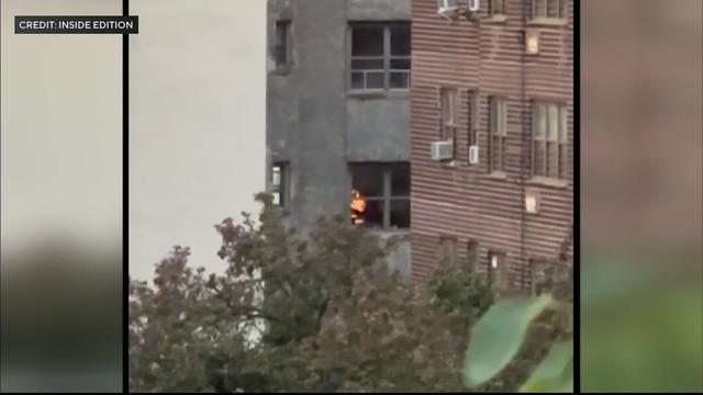 What appear to be flames can be seen through an apartment window in Manhattan. 
