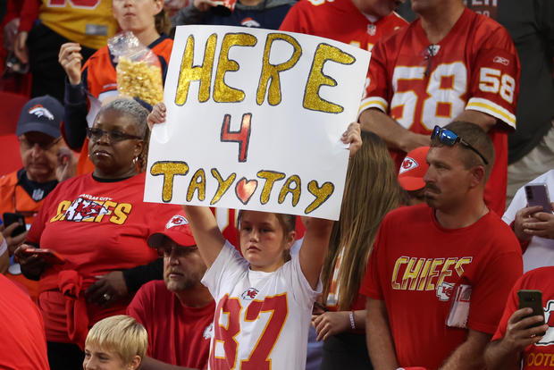A young Taylor Swift fan holds a sign that says, "Here 4 Tay Tay," before an AFC West matchup between the Denver Broncos and Kansas City Chiefs on Oct. 12, 2023, at GEHA Field at Arrowhead Stadium in Kansas City, Missouri. 