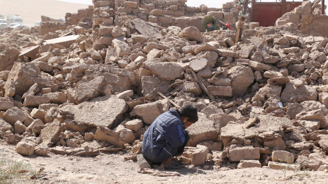 A boy cries as he sits next to debris in the aftermath of an earthquake in Zinda Jan, Afghanistan, Oct. 8, 2023. 