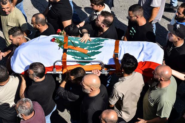 The Lebanese flag-draped casket of Reuters video journalist Issam Abdallah is seen during his funeral in El-Khiam on October 14, 2023. Photo by Fadel Itani/AFP via Getty Images 