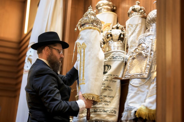 Rabbi Yehuda Teichtal prepares Torah scrolls at the synagogue of the Chabad community on October 13, 2023, in Berlin, Germany, prior to the first Shabbat service after the Hamas attacks on Israel. Photo by Markus Schreiber / AP