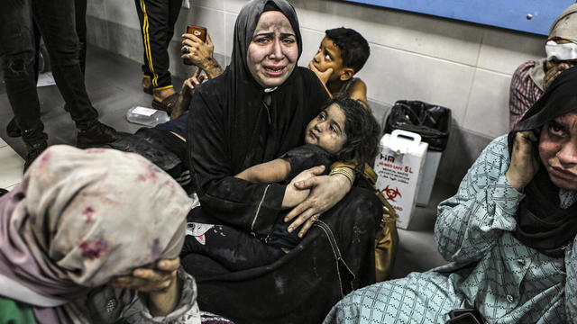 Wounded Palestinians sit in al-Shifa hospital on October 17, 2023, in Gaza City after arriving from al-Ahli hospital following an explosion there. Photo by Abed Khaled/AP. 