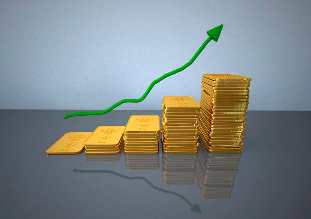 Stack of golden bar with green chart, close up