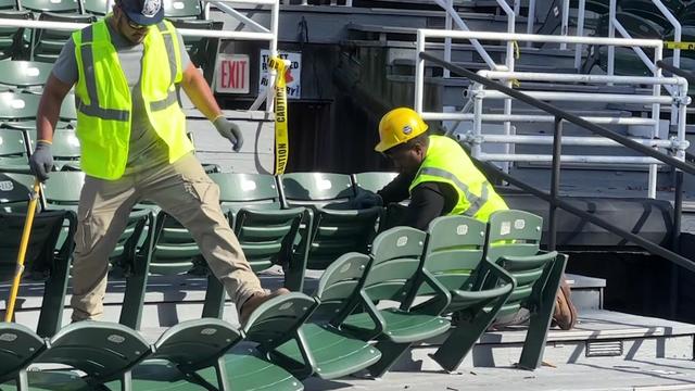 Construction workers tear out rows of seats at the Delacorte Theater. 