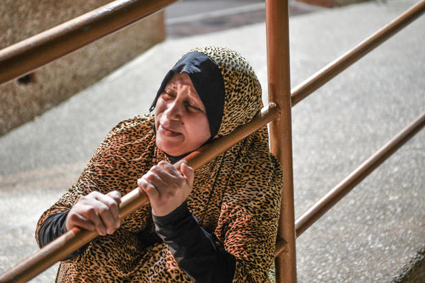 A mother clutches a rail and is seen mourning for her son who died in an Israeli airstrike in Khan Yunis, Gaza on October 18, 2023. Photo by Abed Zagout/Anadolu via Getty Images 