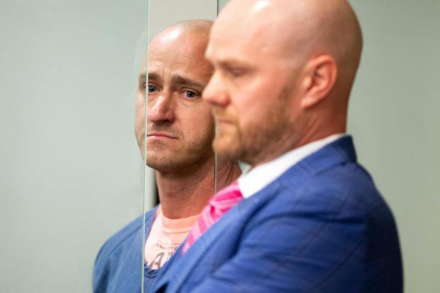 Joseph David Emerson, left, an off-duty pilot who was riding in the cockpit jump seat on an Alaska Airlines flight and was accused of trying to disable the plane's engines, appears with his attorney in Multnomah County court in Portland, Oregon, Oct. 24,  