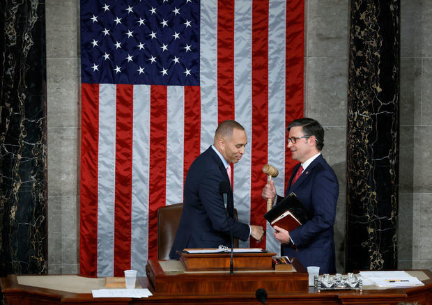 House Minority Leader Hakeem Jeffries hands the gavel to newly elected Speaker of the House Mike Johnson on Oct. 25, 2023. 