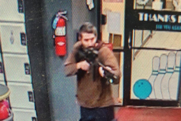 Law enforcement officials released a photo of a man with a semiautomatic rifle suspected in a mass shooting in Lewiston, Maine