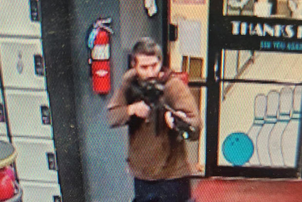 Law enforcement officials released a photo of a man with a semiautomatic rifle suspected in a mass shooting in Lewiston, Maine 