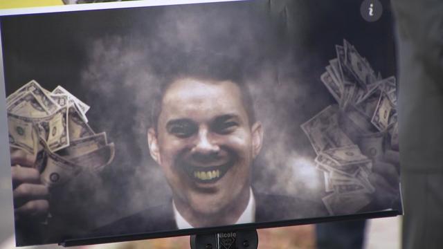 A GOP ad depicting Nassau County Legislator Joshua Lafazan smiling and holding fistfuls of cash. 