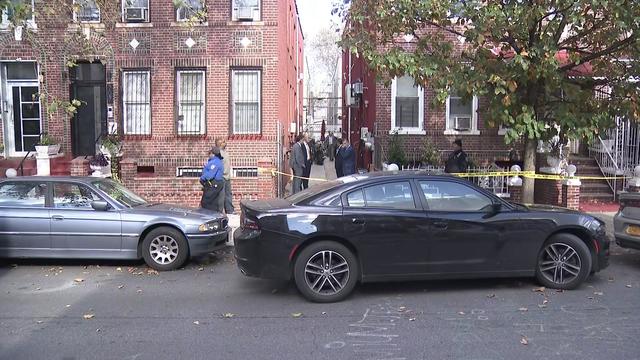 Crime scene tape blocks the sidewalk outside a Brooklyn home. 