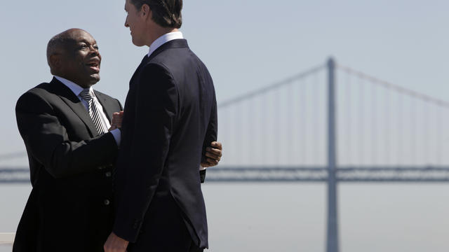 Former San Francisco mayors Willie Brown and Lt. Gov. Gavin Newsom chat before Gov. Jerry Brown signs AB 664 into law, which will help San Francisco finance the infrastructure and create 8,000 jobs for the America's Cup yacht race, at an event held on Pie 