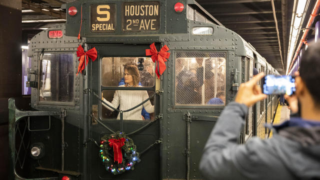 People take a ride in a vintage subway car during Holiday Nostalgia Rides in New York's subway, the United States, Dec. 8, 2019. 