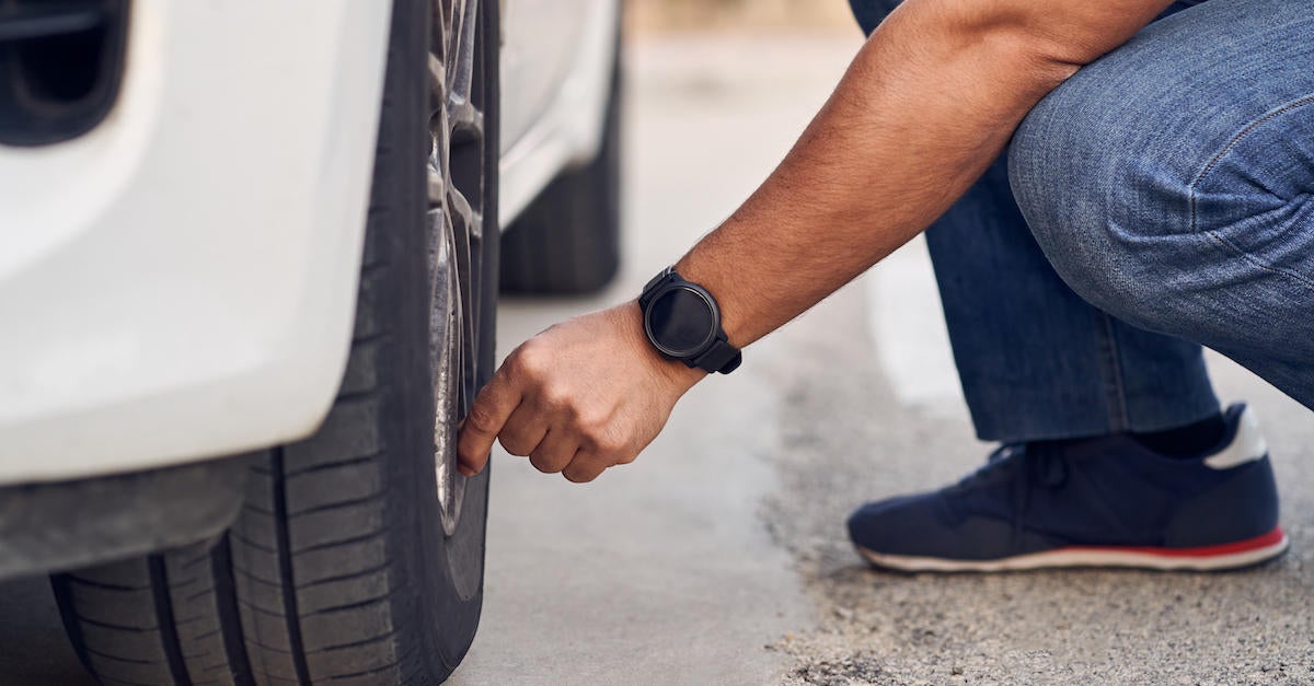 man checking tire 