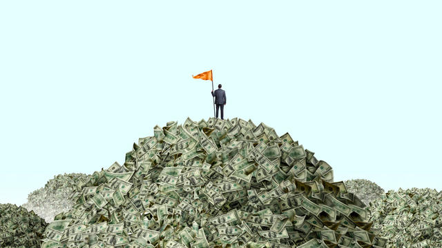 Man Planting Flag On Piles Of Cash 