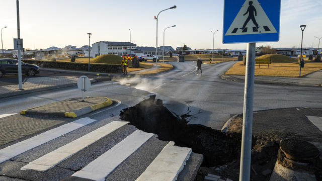 Cracks emerge on a road due to volcanic activity near a police station, in Grindavik 