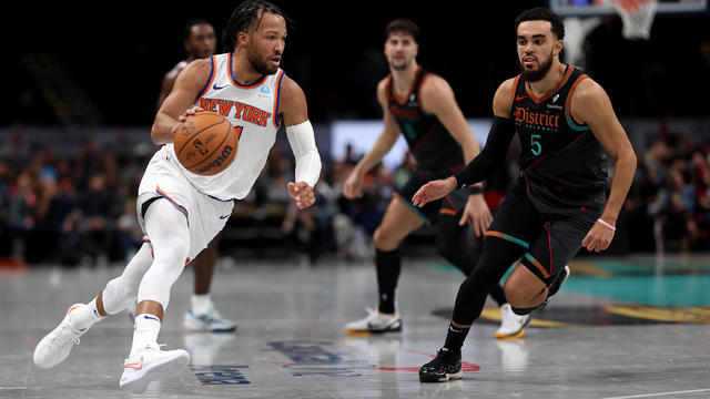 Jalen Brunson #11 of the New York Knicks dribbles the ball in front of Tyus Jones #5 of the Washington Wizards in the first half during an NBA In-Season Tournament game at Capital One Arena on November 17, 2023 in Washington, DC. 