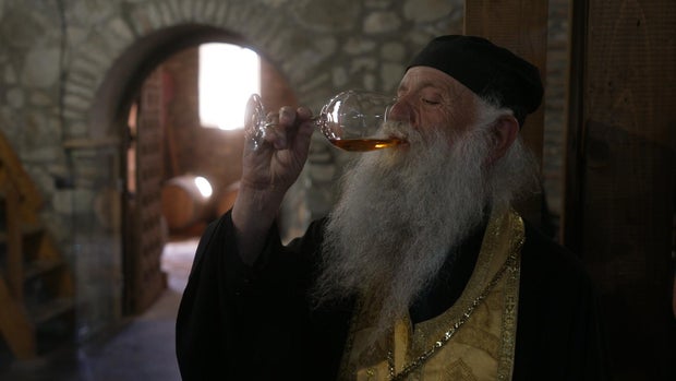 Georgian monk drinks wine