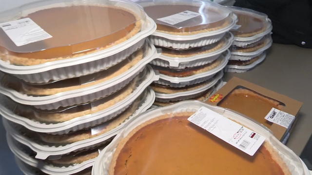 a photo of pumpkin pies stacked up on a table 
