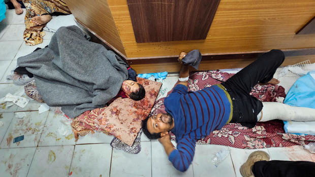 Palestinians wounded in Israeli strikes lie on the floor as they are assisted at the Indonesian hospital after Al Shifa hospital has gone out of service amid Israeli ground offensive 