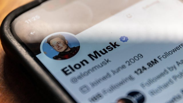 Elon Musk's X (formerly Twitter) bio is seen on a cellphone screen