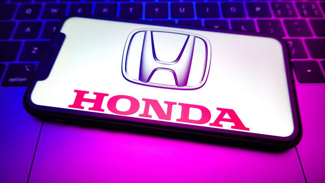 In this photo illustration, a Honda logo is displayed on the 