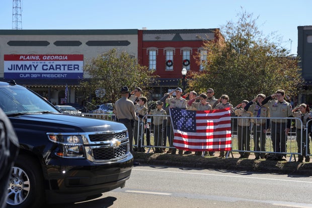A procession carrying the casket of former U.S. first lady Rosalynn Carter passes through downtown Plains